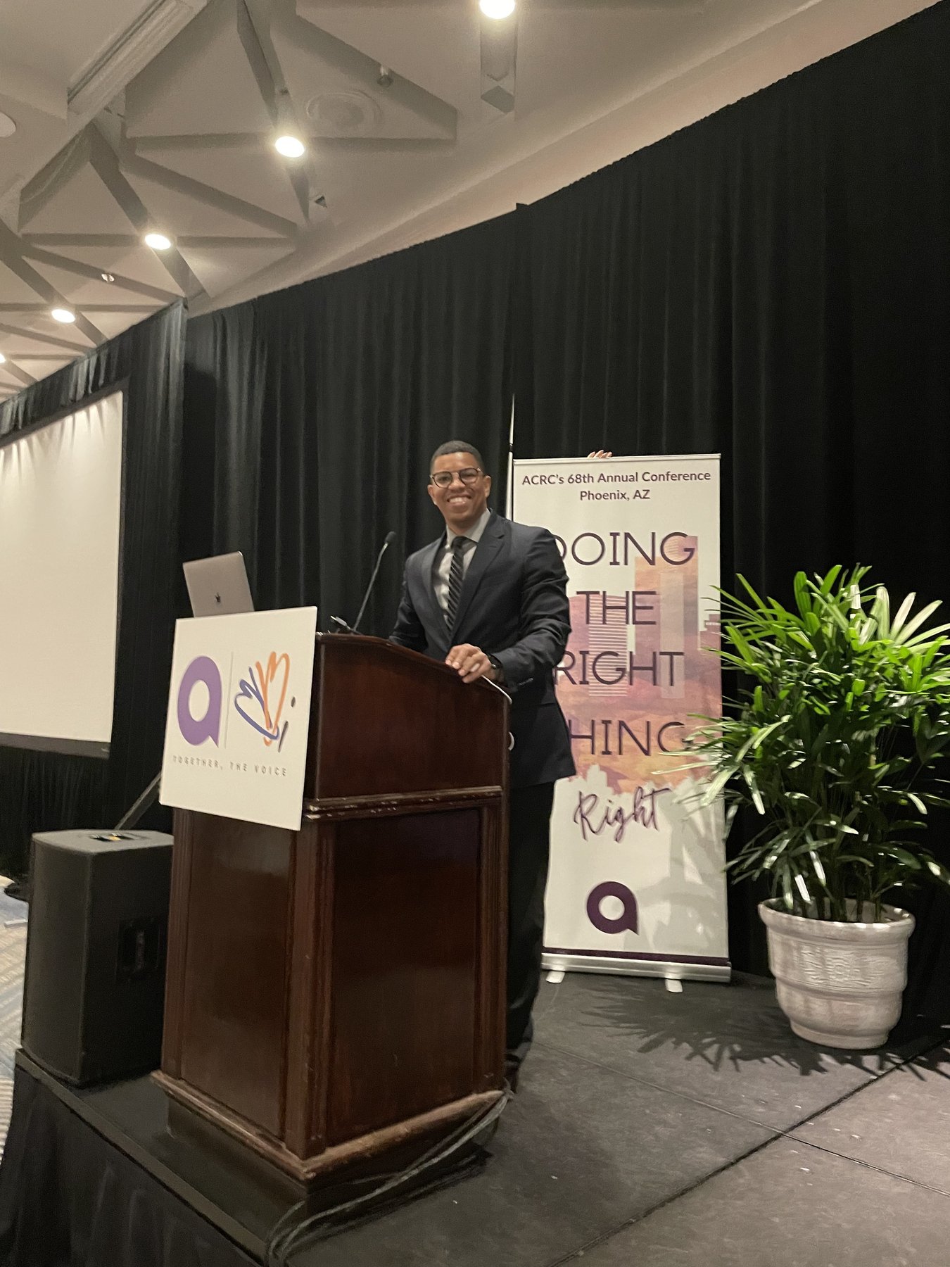 Takkeem Morgan at the podium during the 2024 ACRC 68th Annual Conference in Phoenix, with the Doing the Right Thing, Right banner behind him