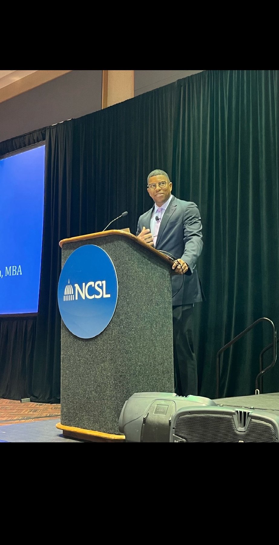 Takkeem Morgan speaking from the NCSL podium in Indianapolis during the 2023 Legislative Summit